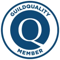 Guild Quality Member circular badge in dark blue and white